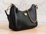 a black purse with a gold chain hanging from the handle