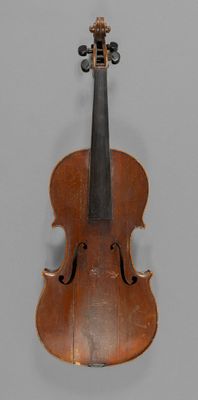 a close up of a violin on a gray surface