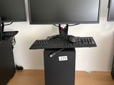 three computer monitors sitting on top of a desk