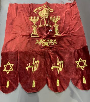 an image of a red and gold cloth with symbols on it