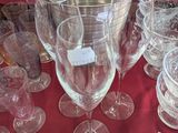 a table with a bunch of wine glasses and plates on it