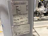 a label on the side of a machine that is sitting on a table
