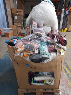 a large teddy bear sitting on top of a cart in a warehouse