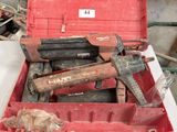 a red tool box with tools in it on a table