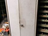 an old refrigerator in the middle of a room next to pallets