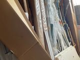 a pile of boxes and a refrigerator in a room