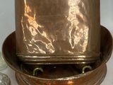 a metal container with a lid sitting on top of a plate