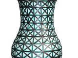 a blue vase that is sitting on a table with a lamp on it