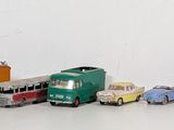 a lot of toy cars that are lined up on the floor
