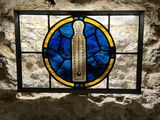 a stained glass window with a picture of a cross on it