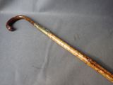 a wooden stick with a handle on a gray surface