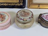 three small boxes sitting on a table next to a framed picture