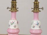 two pink and gold lamps sitting on a table