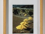 a picture of a picture of a beach with yellow umbrellas
