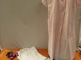 a mannequin on a table with clothing on it
