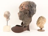 a statue of a man with a beard next to a pair of shoes