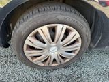 a tire that is sitting on the ground next to a car