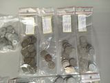 a lot of coins in the bags on the table
