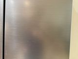 two stainless steel refrigerators side by side next to each other