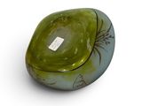 a green and blue bowl sitting on a white surface
