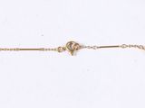 a close up of a gold chain bracelet on a white background