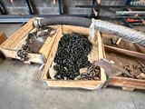 two wooden boxes filled with lots of chains and a hose