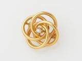 a close up of a gold ring on a white surface