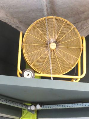 a fan that is sitting on top of a shelf