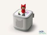 a small speaker with a cat on top of it