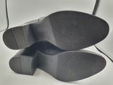 the bottom of a pair of black shoes is shown on a white surface
