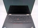 a laptop that is open on a white surface