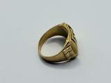 a close up of a gold ring on a white surface