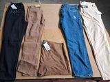five pairs of pants sitting on top of a cardboard box