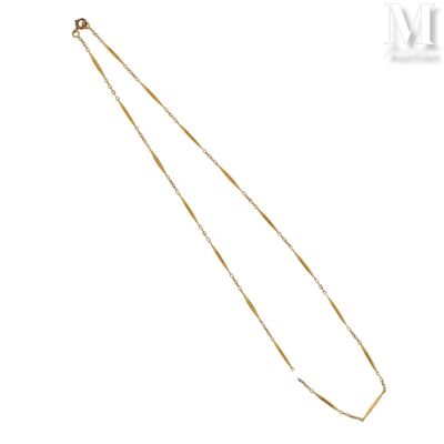 a close up of a gold necklace on a white background