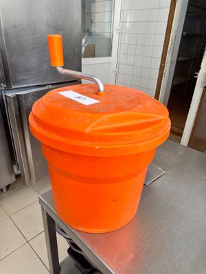 un seau orange posé sur une table dans une cuisine