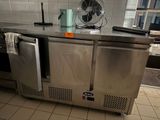 a stainless steel counter with a fan on top of it