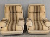 pair of mid century style lounge chairs with striped upholstered cushions