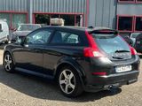 a black car that is parked in front of a building