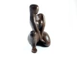 a statue of a woman sitting on a stool