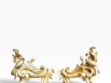 a pair of gold - plated figurines of a man and woman