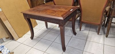 two chairs and a table on the floor in a room