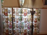 two lamps that are sitting on a rug in front of a window