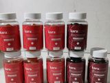 Plusieurs bocaux remplis d'un liquide rouge sont posés sur une surface blanche.