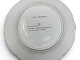 a white plate with a quote on it sitting on a table