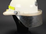 a close up of a white hard hat on a black mannequin head