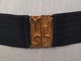 a close up of a belt with a gold buckle on a mannequin dummy