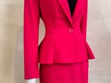 the mannequin is wearing a bright pink suit and black top