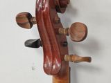 the back of a violin that is sitting on a wooden stand