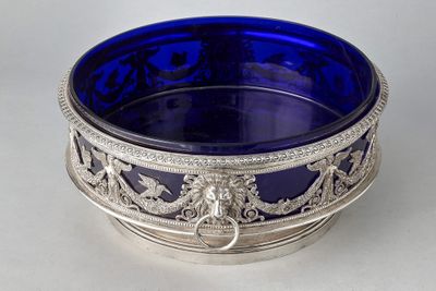 a blue glass bowl sitting on a white table