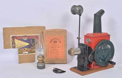 a red and black steam engine with a box and a lamp
